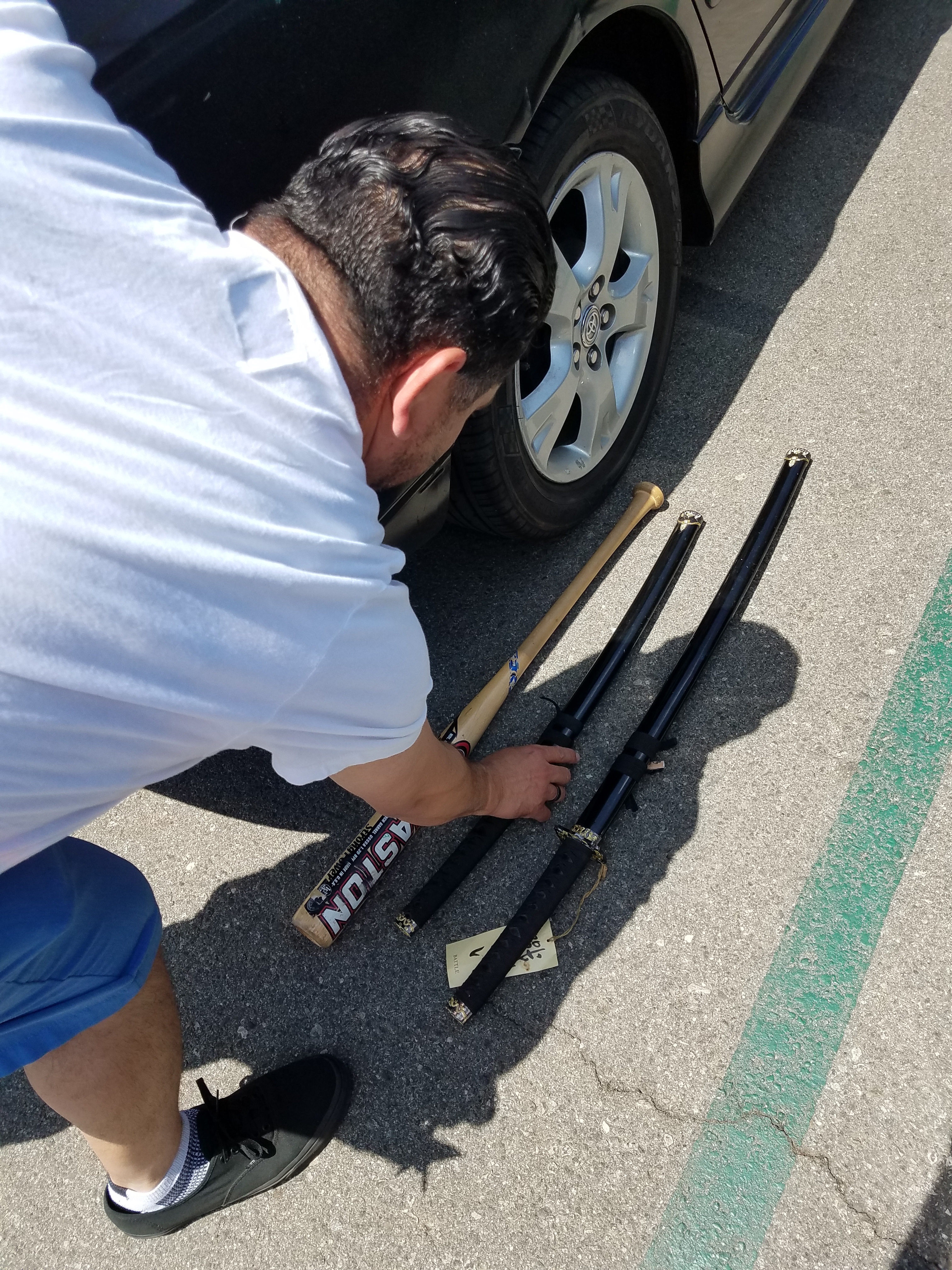 Geo putting his swords and bat on display.